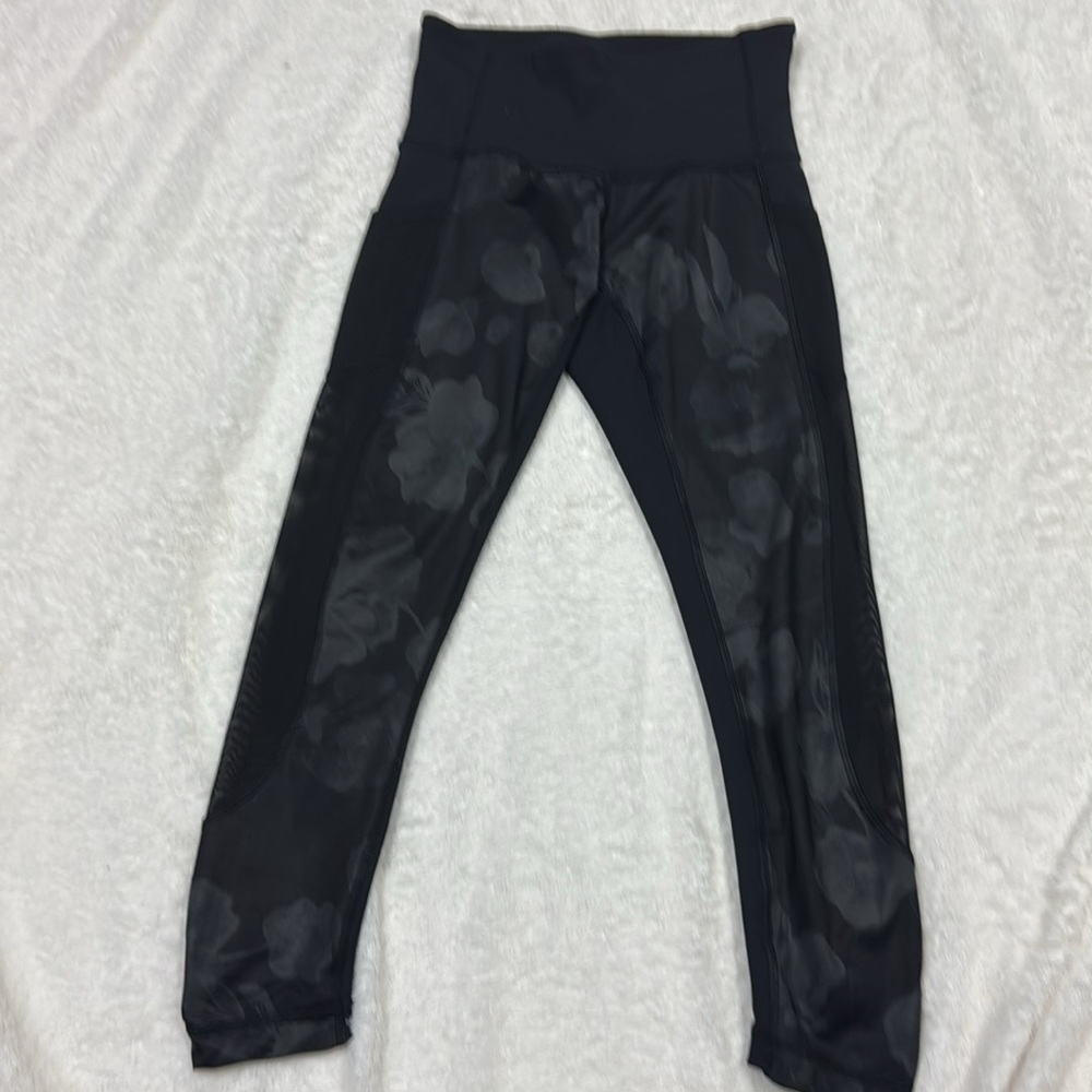 Lululemon leggings.  Seek the Heat black leggings with mesh detailing.